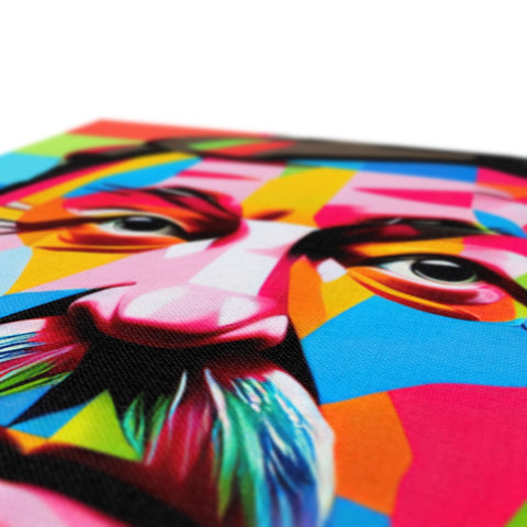A colorful art print sits on top of a bed made into a pillow.
