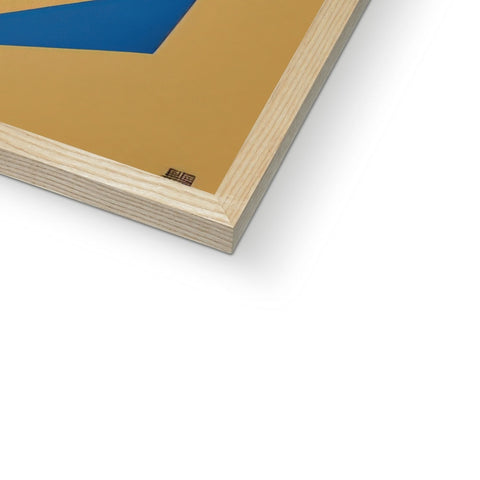 There are gold foil foil pieces on a table topped with a blue wooden book.