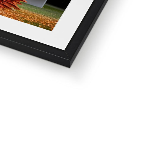 A picture of a photo in a picture frame sitting on top of a tall brick.