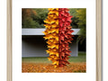 An art print with fall foliage on paper made from white sticks.