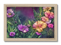 Art print with several colorful flowers on a wood frame on a table in a room.