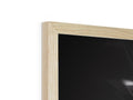 A picture frame with wood panels and a light on a table.