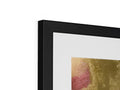 A photo print is framed in a black and gold picture frame.