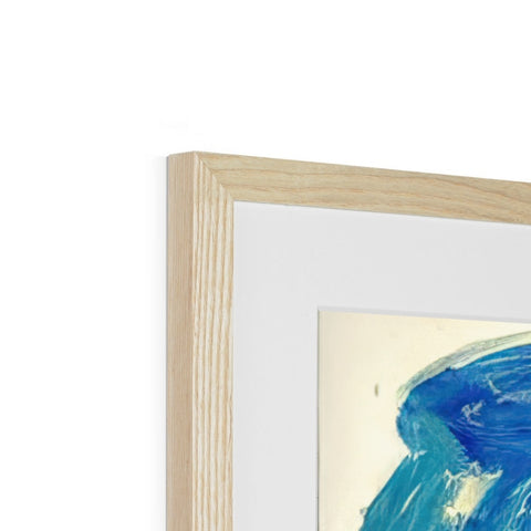 A wooden framed picture of something blue and white on the wall.