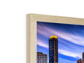 A wooden framed cityscape picture of a downtown Chicago skyline inside of a small brown and