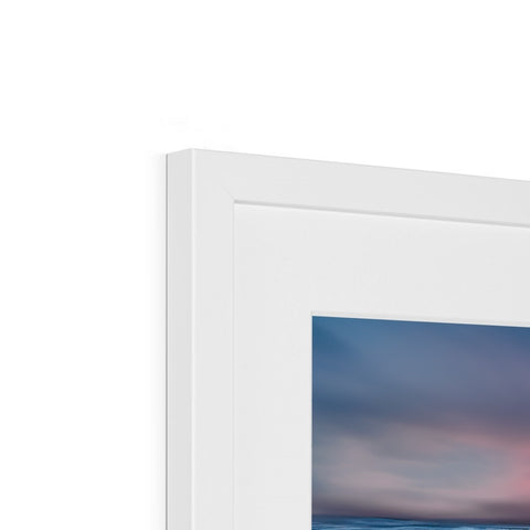 A white picture frame with a white frame in it set on a wall