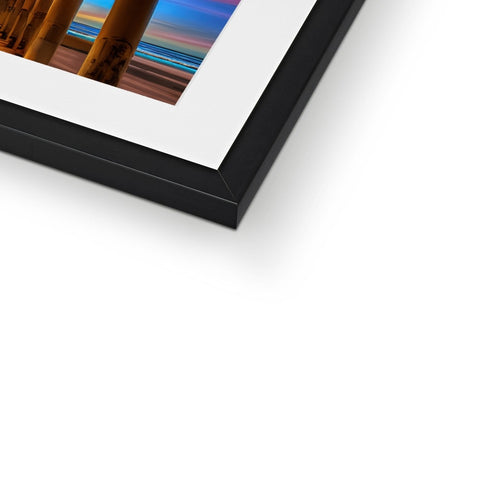 A photo of a picture on a picture frame holding an art print.