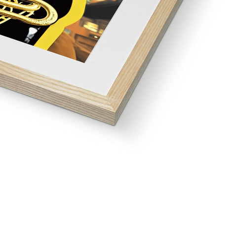 A frame is mounted on a small metal table with gold framed book.