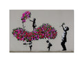 People spraying spray over a wall with flowers at a tree.