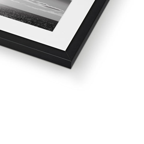 A picture frame containing a silver frame for a framed black and white pic.