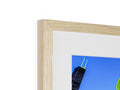 A picture of the city skyline is in a wooden frame on a kitchen table.