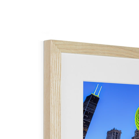 A picture of the city skyline is in a wooden frame on a kitchen table.