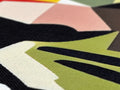 A cloth surface on a table is painted with a colorful blanket sitting on it