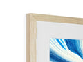 A picture frame with blue and white wood hanging on it next to a wood table set