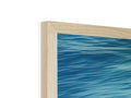 A picture frame on a table with wood wood on a blue background.