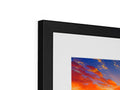 A small picture of a picture frame standing in front of a large flat screen television.