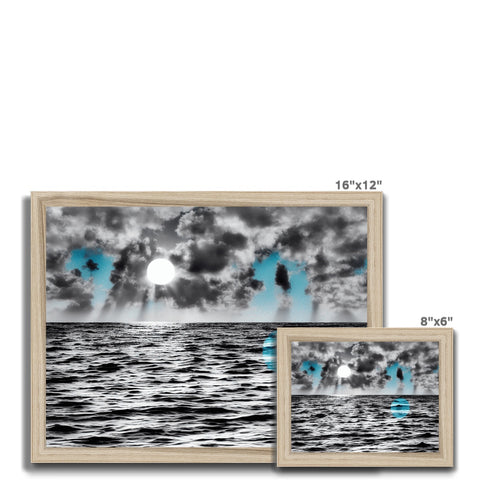 A white picture frame with four white photos of a beach with boats and a sailboat