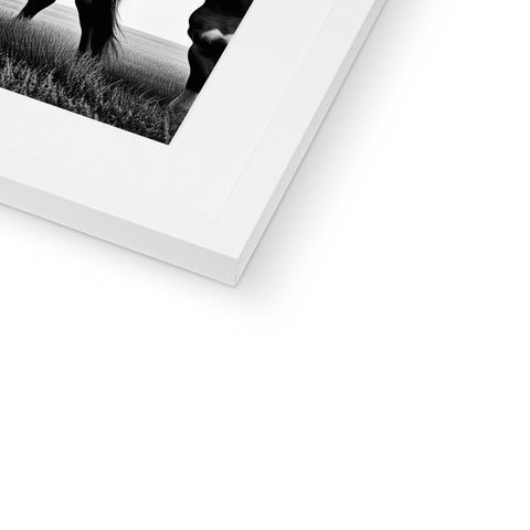 A single photo on a white photo frame next to an album holding three photographs.