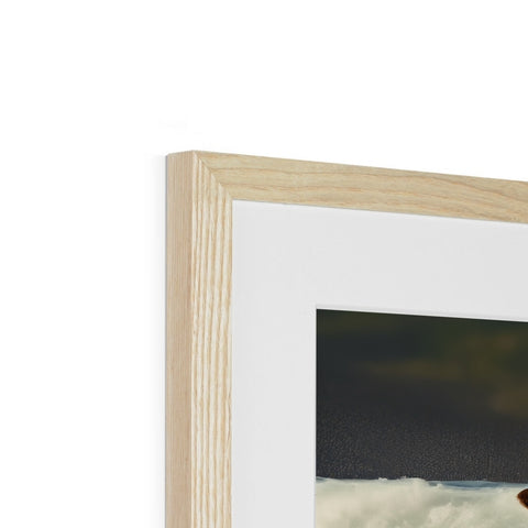 A wooden picture frame has a photo of a dog leaning against a wall.