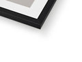 A picture frame on top of a white table with a large mirror and a black frame