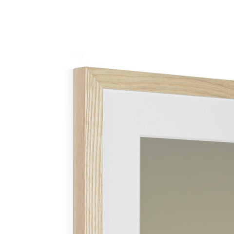 A wooden frame is on top of a white frame in a glass case.