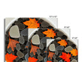 Plastic is placed on a white ceramic tile with autumn leaves in a background.