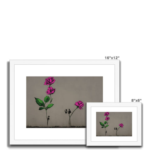 A picture of flower and tree on a wall next to a small picture frame with some