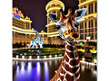 a closeup of a giraffe standing on a marble ground next to buildings on a