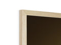 A picture frame that has a frame holding a white background and a black object.