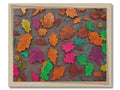 A rug with beautiful Autumn leaves on it, it is sitting on a hardwood wall