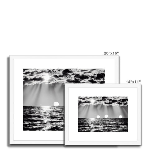 A black and white picture frames with some water and some seascapes nearby.