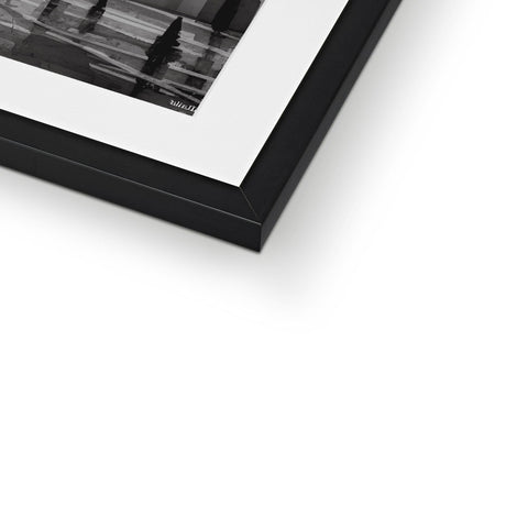 A photo of a black and white picture frame sitting on top of a shelf.