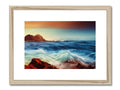 A framed picture of a seascape on a picture board with a sun setting in
