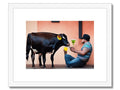 A cow is licking a hot looking cow on its side while he is drinking milk.