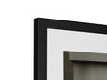 A rectangular picture frame sitting on top of a very white wall.
