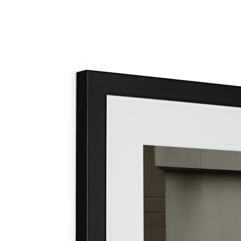 A rectangular picture frame sitting on top of a very white wall.