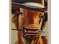 a large red cow grazing in the grassA close up photo of a cowboy in the