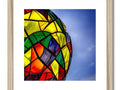a framed picture of rainbow kites sitting in a beautiful stained glass dome next to a