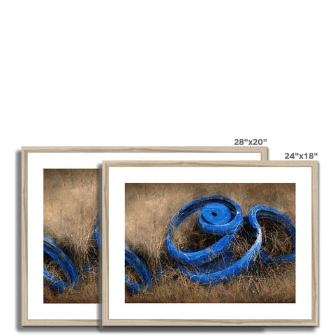 A white metal frame containing a blue ribbon with dried grass with a closeup of a