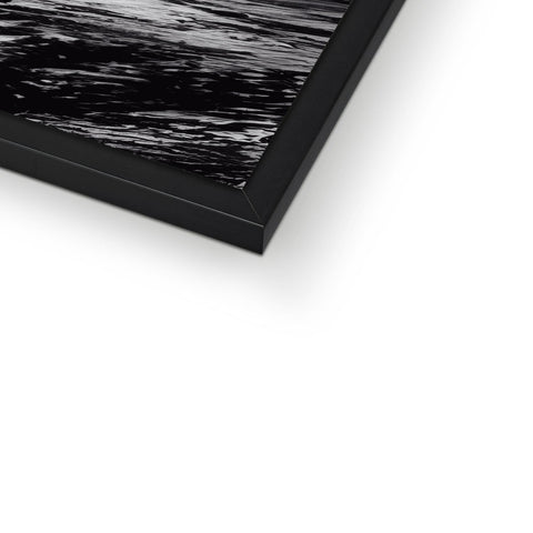 A framed picture is on a black and white photo frame with a black frame.
