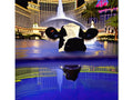 a cow standing near a body of water in downtown Nevada