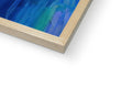 A wooden picture frame is in front of a painting with blue paint and yellow shading and