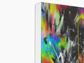 A painting is painted with bright white spray paint on the back of a box.