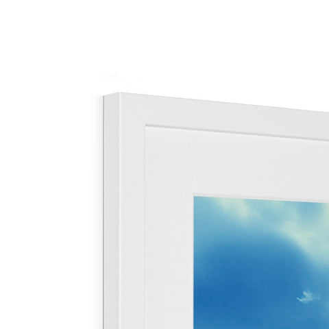Two photo frames are placed within a white frame in a window.
