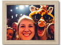 A giraffe posing for photos with a photograph in a wooden frame
