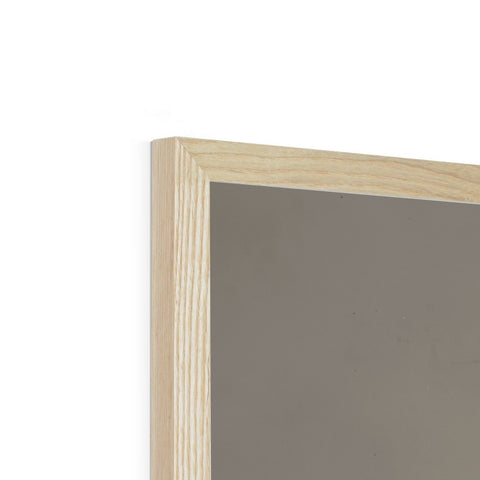 A picture frame sitting on top of a wooden table is reflected against a white wall.