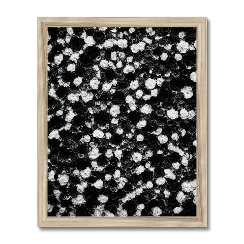 A granite countertop with a black and white picture hanging on the wall