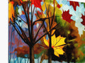 A picture of autumn foliage painting on a easel and a pair of trees and a