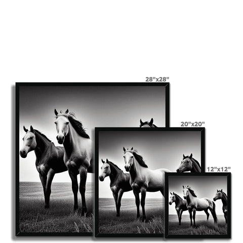 A picture frame with a black and white picture of three horse under a sunbeam next