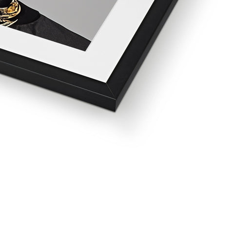 a picture frame with black wooden frame has a golden frame and white and silver decorations